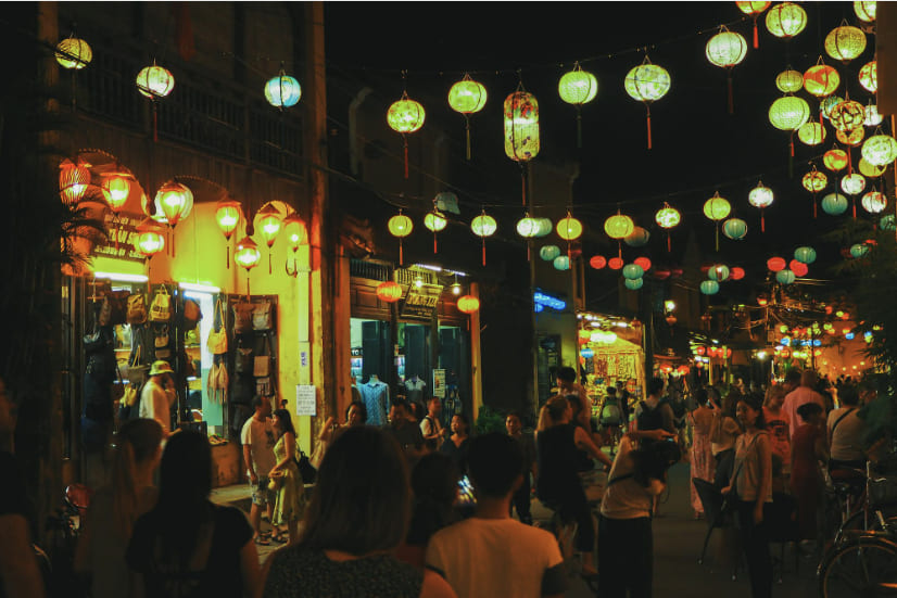 Colorful lanterns reflecting on Thu Bon River at night in Hoi An